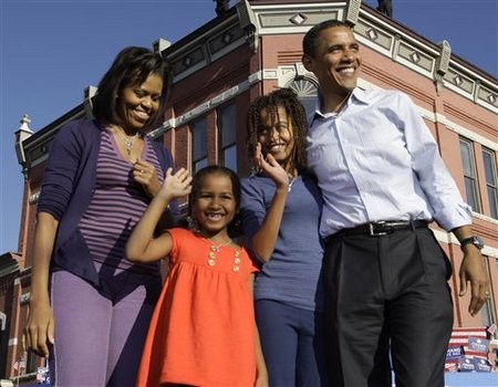 Sen. Barack Obama, D-Ill., waves at a rally with his wife Michelle Obama and daughters Malia Obama, 10, and Sasha Obama 7, in Pueblo, Colo. Saturday, Nov. 1, 2008