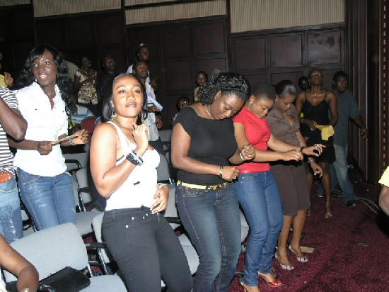 Ladies on front row (second left onwards) dancing with heads bowed, a
new style?