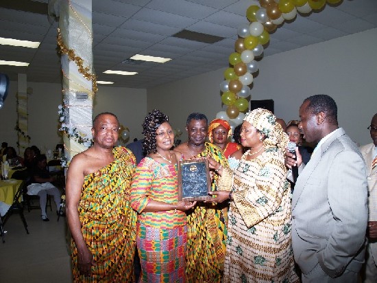 Mrs Owusu Safo is presented with an award.  With the microphone is Mr. Kwame Asumeng, New York Public Health Department official and Special aide to the New York Asantefuohene.