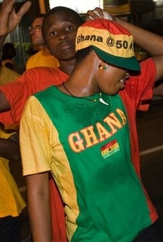 People dance in the street during Ghana's 50 years of independence celebrations