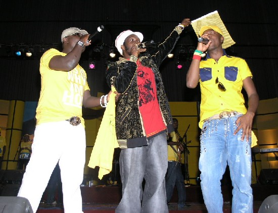 The MCs; Bola Ray and KOD with Mr. Vegas on stage