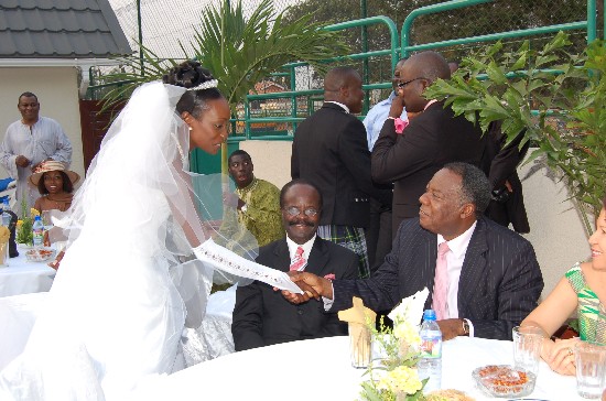 The bride shakes hands with Nick Amartefio, CEO of Citi FM, as Public Sector Reform Minister, Dr. Kwesi Nduom looks on