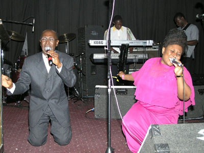 Rev. Darko and Felicity Amoah on their knees as Rev. Darko led in worship.