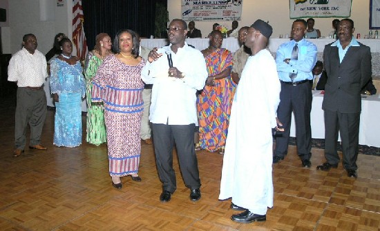 Hon. Obeng Gyan-Busia (center with mic) get ready to swear in the new executives, Supported by Ms Rose Quarshie (standing next to Hon. Gyan-Busia on the left) and Alhaji Mardah (standing right next to Hon. Gyan-Busia)