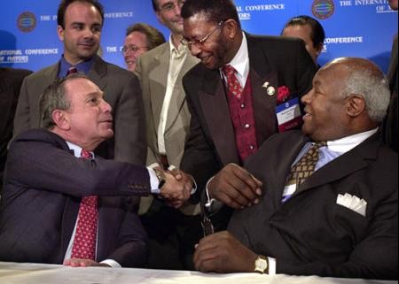 Hempstead, NY, Mayor James Garner, seated right, introduces New York Mayor Mike Bloomberg, seated left, to Mayor Solomon Darko of Accra, Ghana during the meeting of the U.S. Conference of Mayors in New York, Friday April 19, 2002. After exchanging ideas f