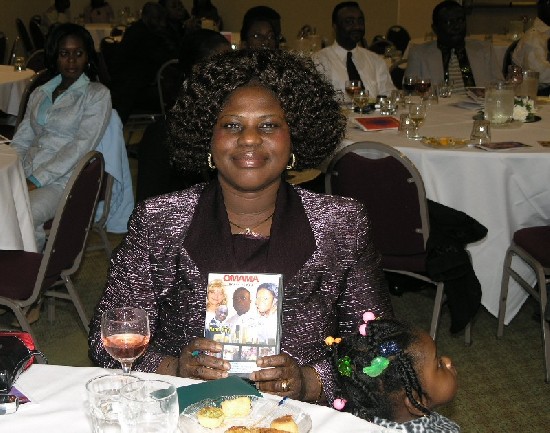 Ms Rose Antwi, the winner of the auction shows the first DVD.