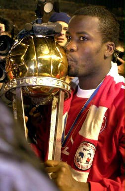 Sammy Kuffour of Ghana kisses the trophy