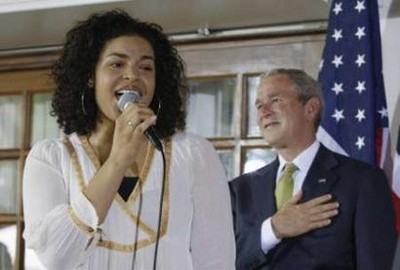 U.S. President George W. Bush (R) listens as 2007 American Idol winner Jordin Sparks sings the U.S. National Anthem during a visit to the U.S. Ambassador's residence in Accra February 20, 2008