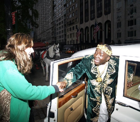 A tourist greets Papa as he arrives from the Rolls Royce