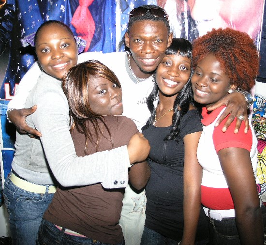 Agya Koo surrounded by some of his fans