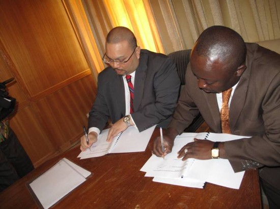 Mr Baba Jamal, Deputy Minister of Information with Mr Shariman Zainal Abidin signing the document.