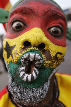 A man painted with Ghanaian colours dances during celebrations of the 50th anniversary of Ghana's independence in Accra.