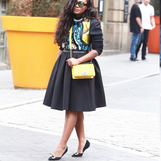 Dress Flat Shoe:Here a black dress flat shoe with ribbon embellishments in black and silver is paired with a lovely black pleated full skirt  faux leather artsy top, yellow full chain bag and huge sun shades.