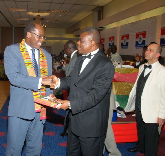 Mr. Mac Manu (right) presenting an award to the winner of
an auction