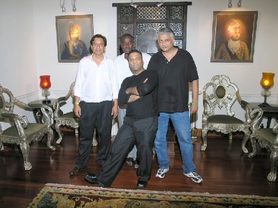 The owners of the Heritage Mansion and Sammy Tuga pose