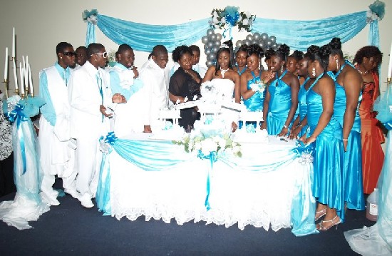 Pauline is assisted by her mother and friends to cut the birthday cake