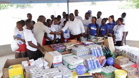 Head of customer operations Steven Essien presenting items to the Dworwulu special school