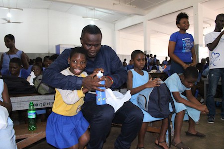 Qweci Oteng Feeding a pupil of the Akropong School for the Blind