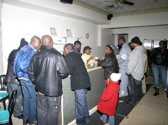 The restaurant is filled with guests ordering their food.