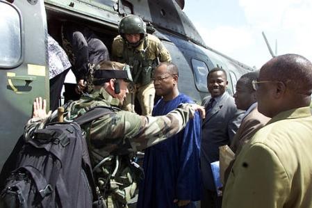 A French soldier talks to Mohamed Ibn Chambas, executive secretary of the Economic Community of West African States (ECOWAS), center