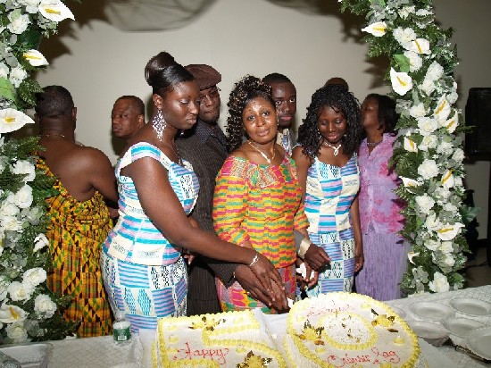 The cutting of the cake, she is supported by her children; Nana Konadu (left), Michael (second left), Yaw Owusu Sarfo and Yaa Boatemaa.