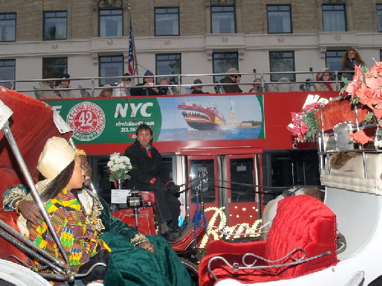 Road block - A tourist guide in the double decker bus and the horse carriage driver stopped to watch causing a traffic jam.