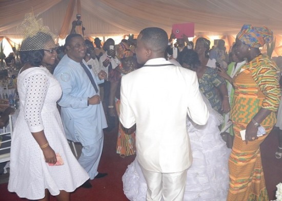 Bride and groom on the dance floor with others