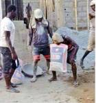 Man carries bag of cement with his teeth