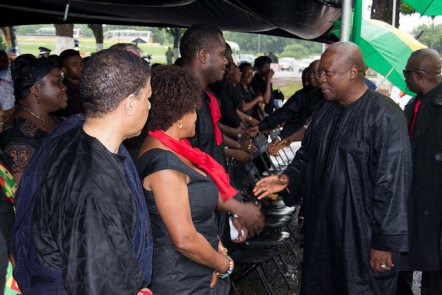 Mahama shakes hands with members of the Okoh family