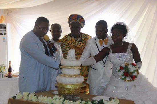 Couple cutting cake with guests