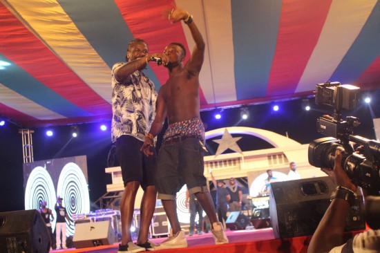 Fan joins Samini on stage.