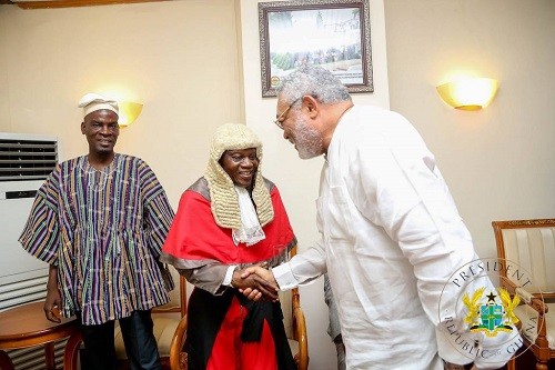 Former President Jerry John Rawlings shakes hand with Justice Atuguba, looking on is Haruna Iddrisu