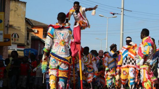 Man on stilts towers over other people on the parade
Stilt-walkers are highly sought after, giving clubs an easily recognisable mascot for their parades