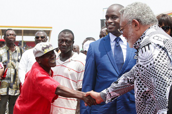 Ex President JJ Rawlings in a handshake with a citizen at the Ghana@59