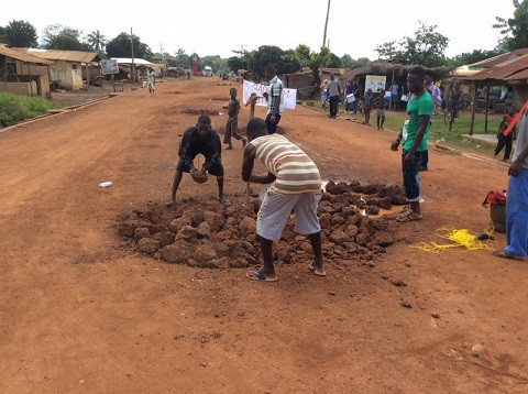 Some youth fixing the deplorable road