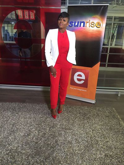 Waje suits up in red jumpsuit for live Africa Day performance in S.A