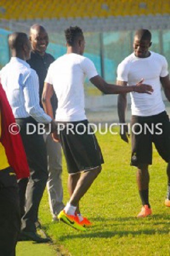 Tony Baffoe looks on as Boye tries to shake Jonathan Mensah's hand