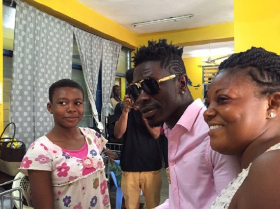 Shatta Wale interacting with the children